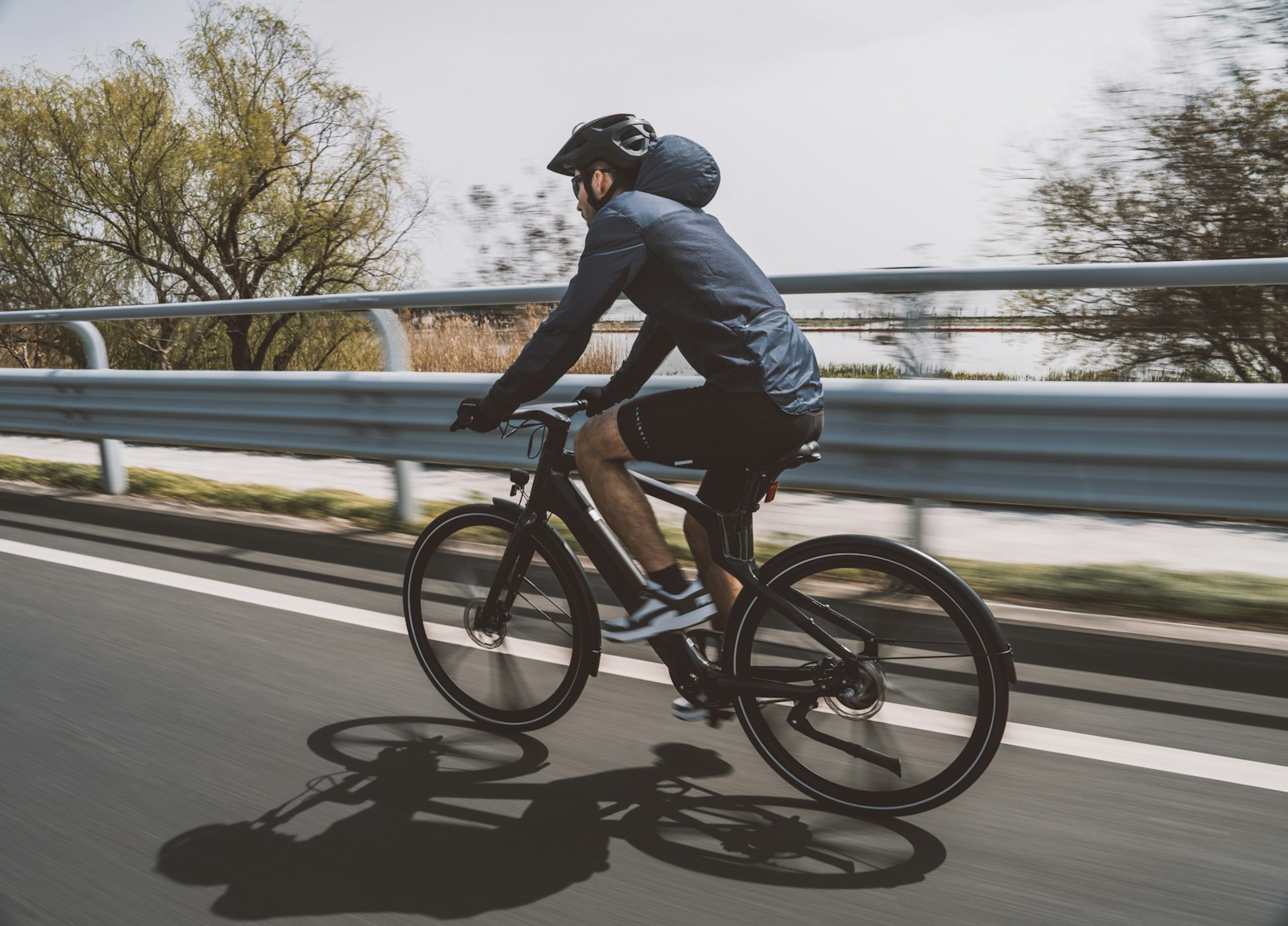 a man riding a bike down a street